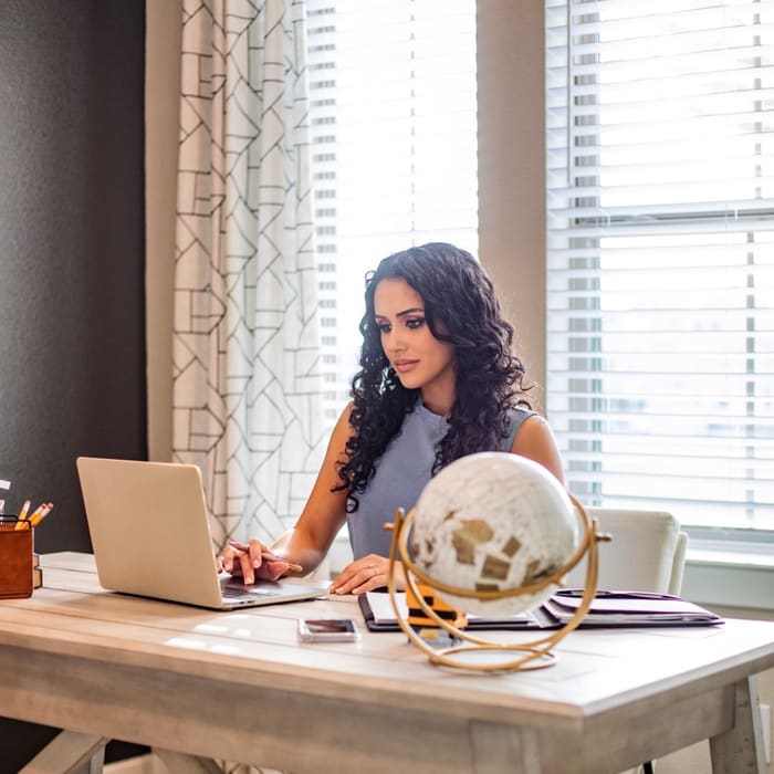 Laptop and workspace for online notary sessions in Texas.
